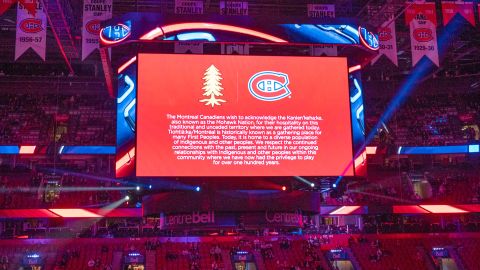 An NHL game between the Montreal Canadiens and San Jose Sharks opens with a land acknowledgment shown on the scoreboard.