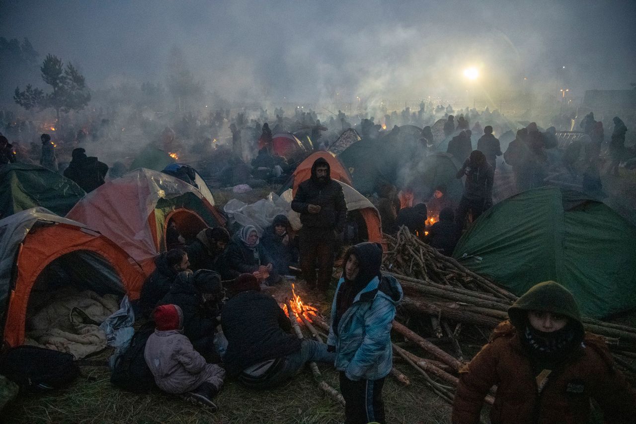 Migrants gather around fires as they camp near the Poland-Belarus border on Tuesday, November 16. Hundreds of migrants — most of whom are from the Middle East and Asia — <a href="http://www.cnn.com/2021/11/11/europe/gallery/poland-belarus-border-crisis/index.html" target="_blank">have been enduring grueling conditions</a> in hopes of getting into Poland and then deeper into Europe.