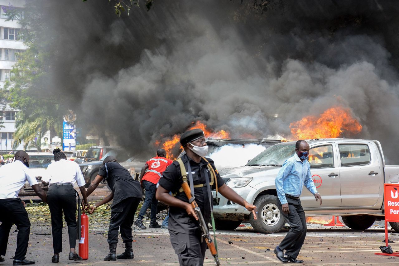 People work to extinguish fires after a bomb exploded near the parliament building in Kampala, Uganda, on Tuesday, November 16. The Islamic State claimed responsibility for <a href="https://www.cnn.com/2021/11/17/africa/uganda-islamic-state-bombing-intl-hnk/index.html" target="_blank">two separate suicide attacks</a> that killed three people and injured 36.