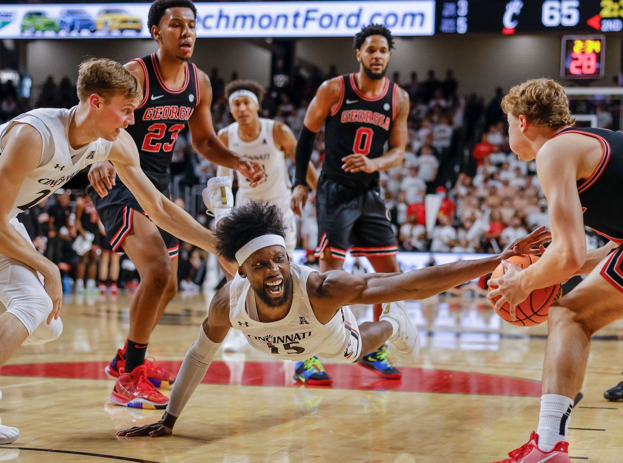 Cincinnati's John Newman III dives for a loose ball during a college basketball game against Georgia on Saturday, November 13.