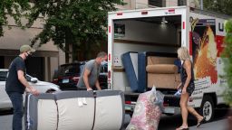 People wearing masks load furniture into a U-haul moving truck as the city continues Phase 4 of re-opening following restrictions imposed to slow the spread of coronavirus on September 12, 2020 in New York City. 