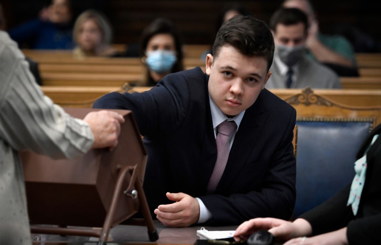 Kyle Rittenhouse pulls numbers out of a tumbler during his homicide trial in Kenosha, Wisconsin, on Tuesday, November 16. There were 18 potential jurors who heard the evidence and testimony in his case, but only 12 will decide his fate. <a href="https://www.cnn.com/us/live-news/kyle-rittenhouse-trial-verdict-watch-11-16-21/h_c08e5f3c0c285a7287ac8fce9190842a" target="_blank">The lottery</a> decided which six would be alternates.