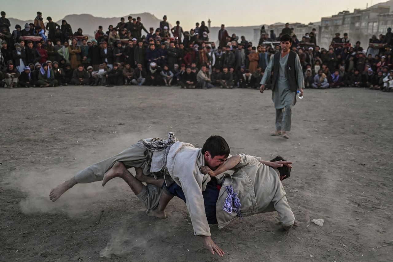 Men wrestle in front of a crowd at a makeshift arena in Kabul, Afghanistan, on Friday, November 12. 