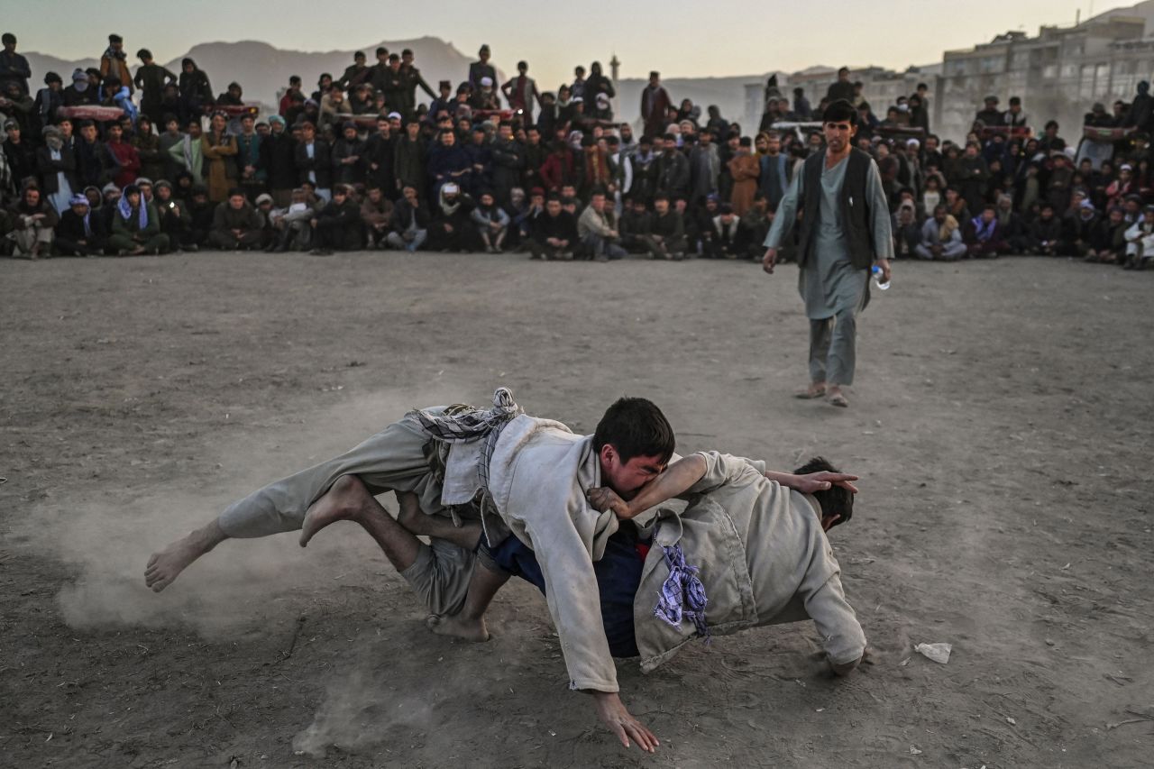 Men wrestle in front of a crowd at a makeshift arena in Kabul, Afghanistan, on Friday, November 12.