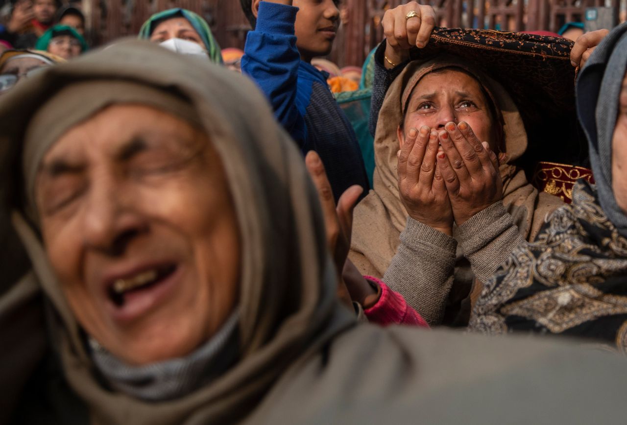 Muslim devotees weep as a priest displays a relic of Sufi saint Sheikh Syed Abdul Qadir Jeelani outside his shrine in Srinagar, India, on Wednesday, November 17.