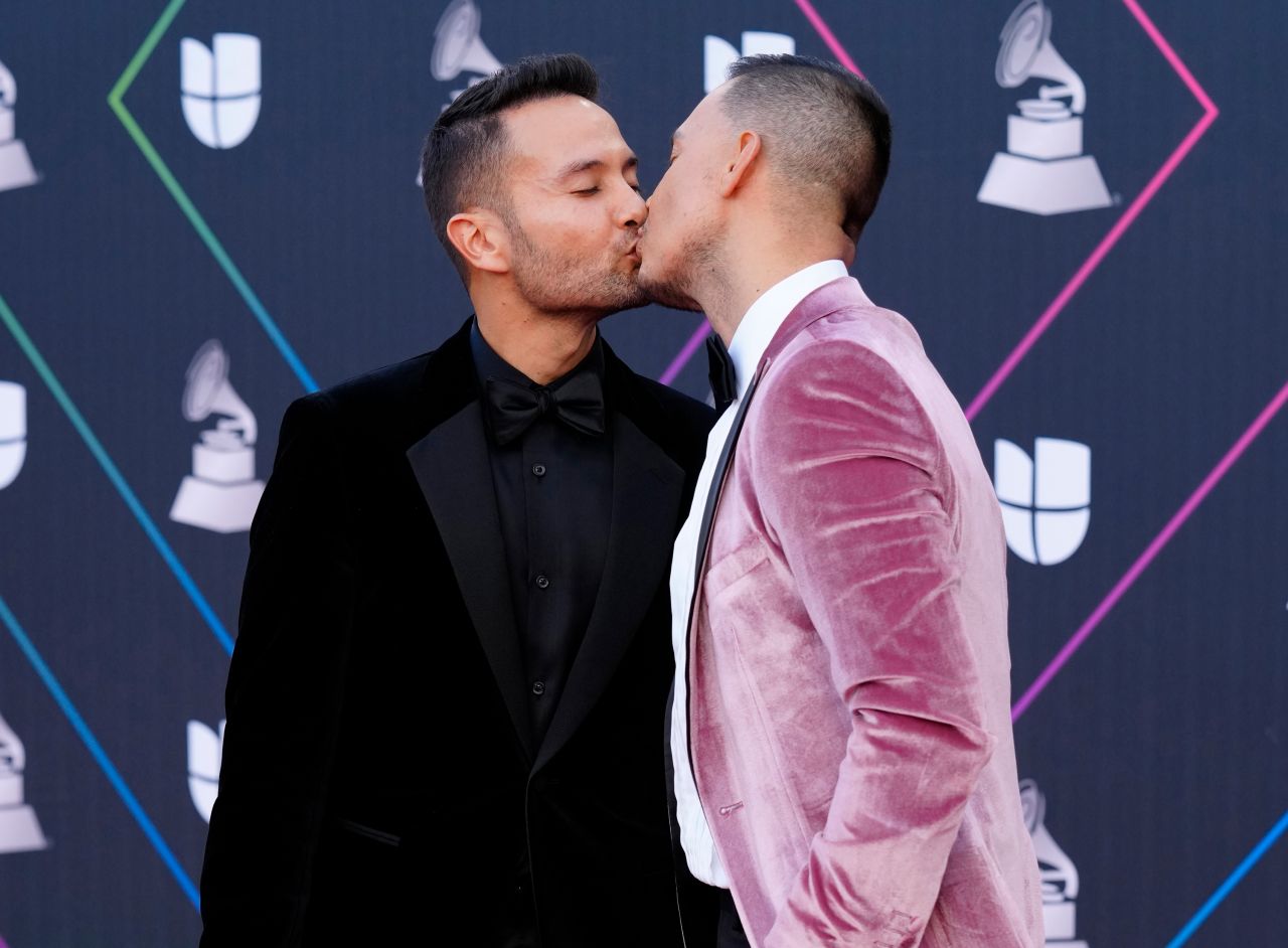 Luis Sandoval and Renato Perez kiss on the red carpet, ahead of the 22nd annual Latin Grammy Awards.