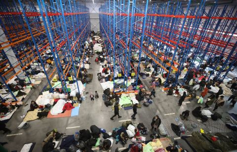 Migrants settle for the night on Thursday, November 18, in a warehouse near the Bruzgi-Kuźnica crossing serving as an ad hoc processing center.