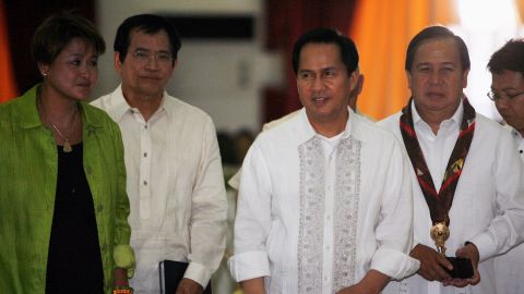 International evangelist Pastor Apollo Quiboloy (2nd R) walks with presidential candidates attending his 60th birthday celebration in Davao City, southern Philippines on April 25, 2010.