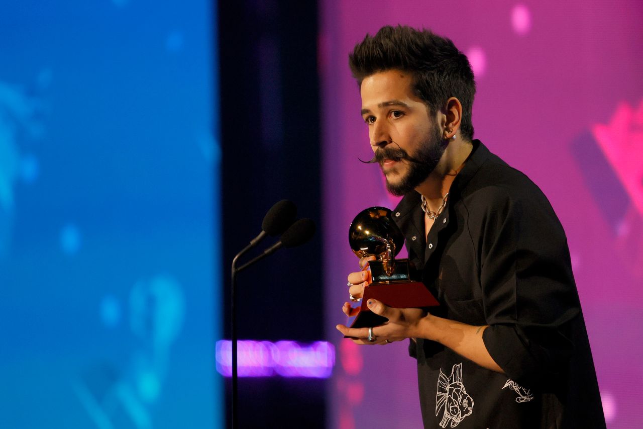 Camilo accepts the <a href="https://www.cnn.com/entertainment/live-news/latin-grammys-2021/h_6d625b9fd8f243568795c81ad7fd5120" target="_blank">Best Pop Vocal Album</a> award for "Mis Manos.".