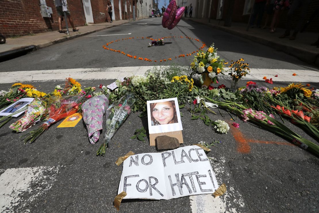 CHARLOTTESVILLE, VA - AUGUST 13:  Flowers surround a photo of 32-year-old Heather Heyer, who was killed when a car plowed into a crowd of people protesting against the white supremacist Unite the Right rally, August 13, 2017 in Charlottesville, Virginia. Charlottesville is calm the day after violence errupted around the Unite the Right rally, a gathering of white nationalists, neo-Nazis, the Ku Klux Klan and members of the 'alt-right,' that left Heyer dead and injured 19 others.  (Photo by Chip Somodevilla/Getty Images)