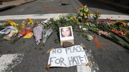 Flowers surround a photo of 32-year-old Heather Heyer, who was killed when a car plowed into a crowd of people protesting against the white supremacist Unite the Right rally, August 13, 2017 in Charlottesville, Virginia. 