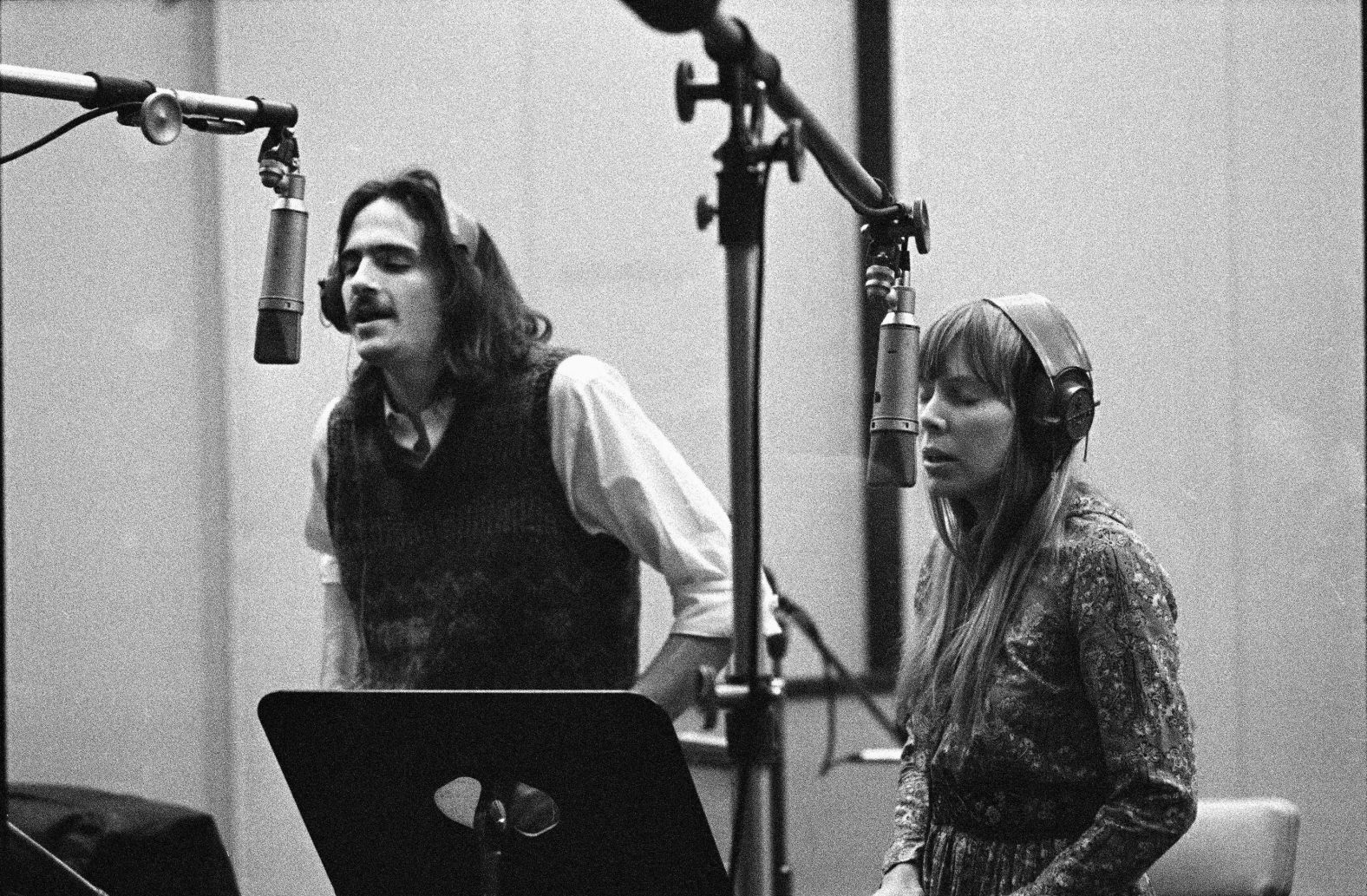 Taylor and Joni Mitchel recording backing vocals for Carole King's album, <a href="index.php?page=&url=https%3A%2F%2Fwww.cnn.com%2F2021%2F02%2F10%2Fentertainment%2Fcarole-king-tapestry-trnd%2Findex.html" target="_blank">"Tapestry."</a> The 1971 album won Grammy Awards for album of the year and best pop vocal performance, among numerous other acknowledgments.
