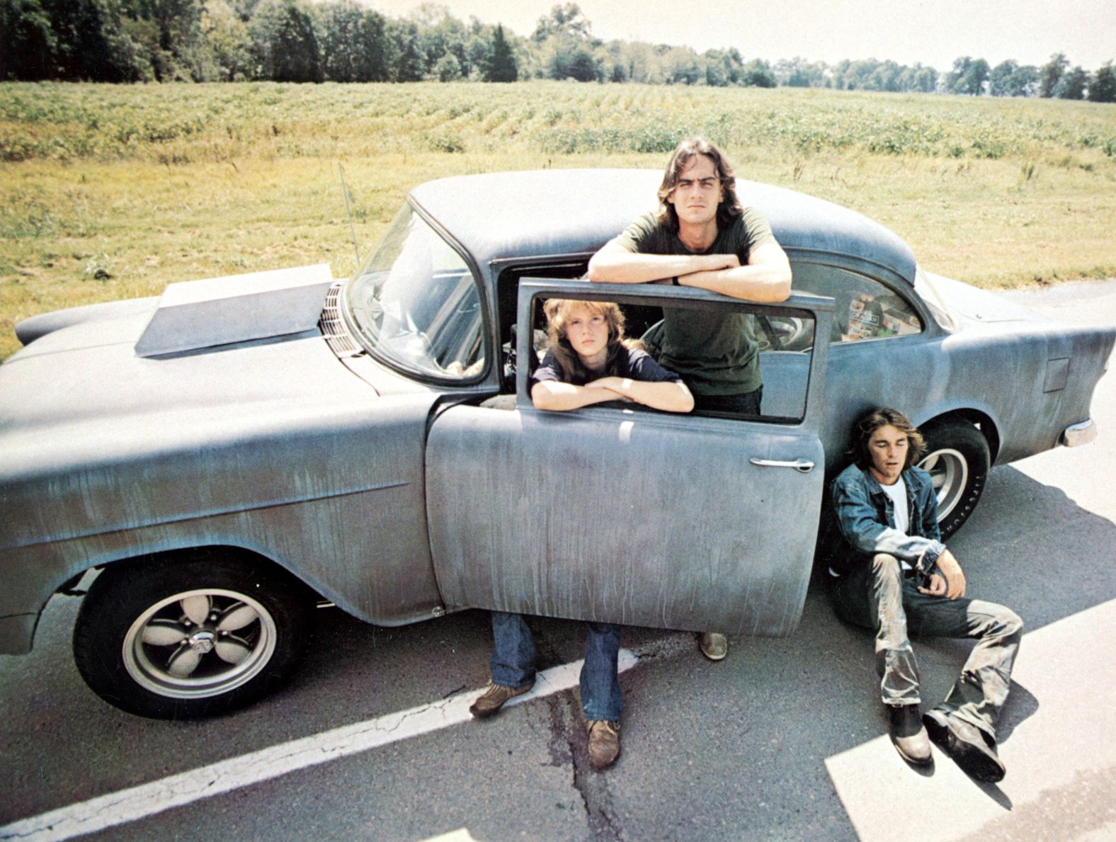 Taylor poses with actress Laurie Bird and Beach Boys drummer Dennis Wilson for "Two-Lane Blacktop," a 1971 road film. The movie is about drag-racers and Taylor plays the driver.