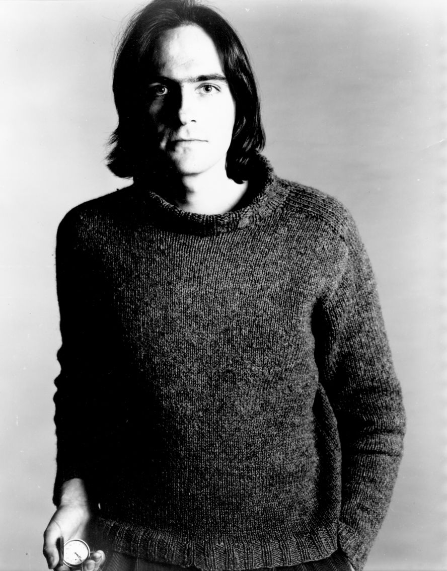 Taylor poses for a portrait holding a pocket watch in 1974.