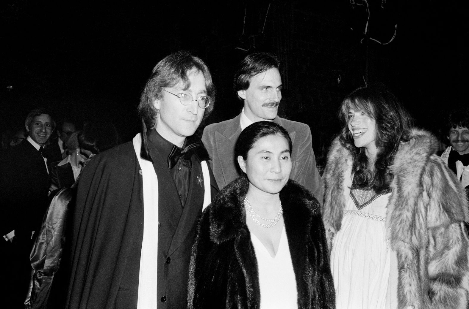 Taylor, Simon, Yoko Ono and John Lennon stand together in New York in 1977.