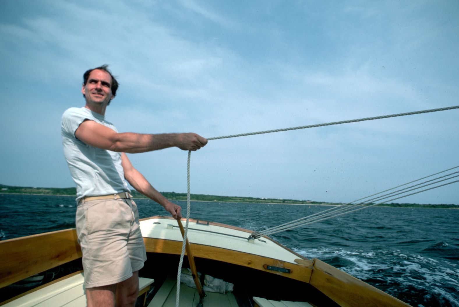 Taylor rides on a sailboat and pulls on a rope.