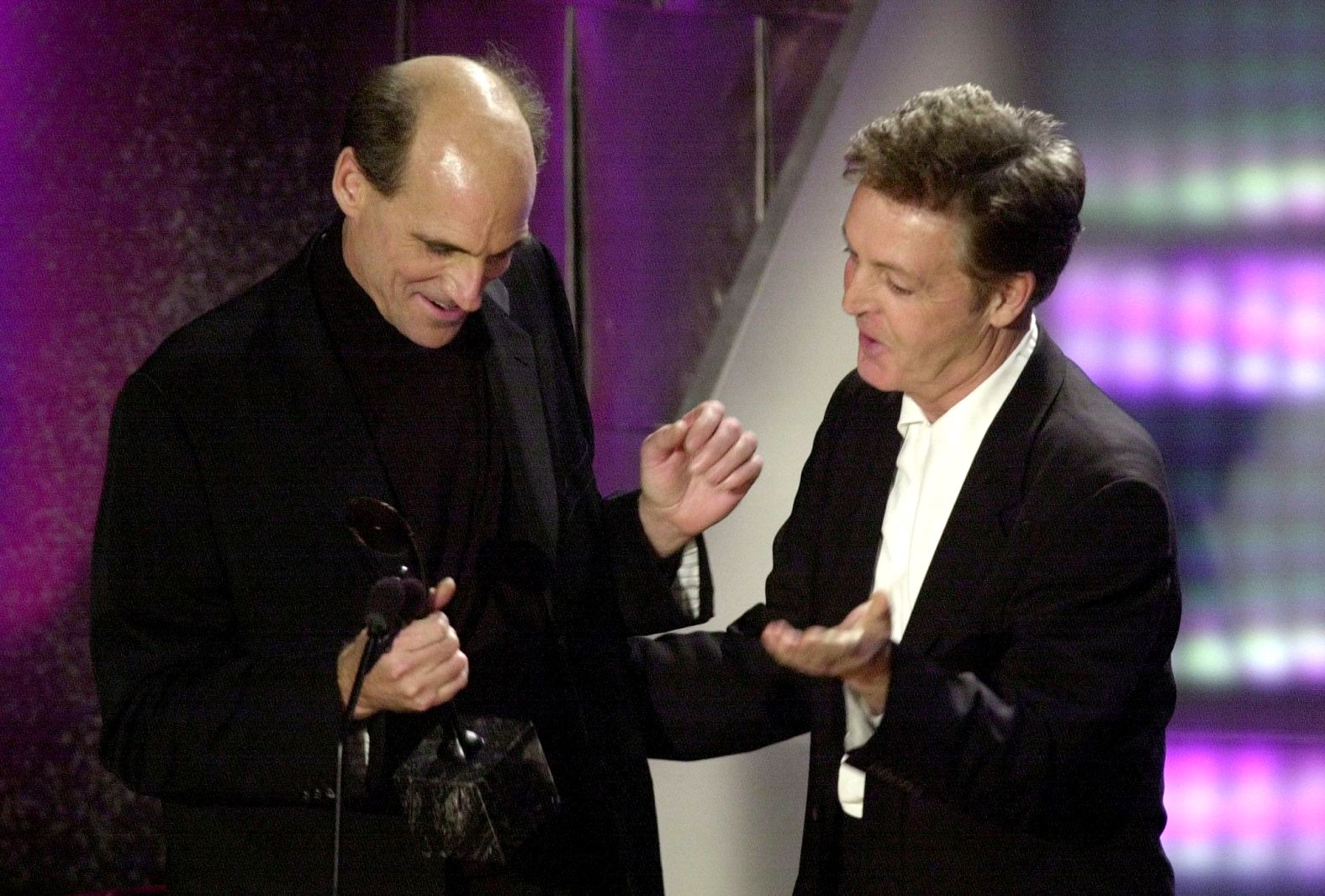 Paul McCartney hands Taylor his award during induction ceremonies of the Rock and Roll Hall of Fame in March 2000. Taylor was inducted along with Eric Clapton, Earth, Wind & Fire, the Lovin' Spoonful, the Moonglows and Bonnie Raitt. "I love him. He's a really beautiful guy. We had a lot of really good times back then," <a href="index.php?page=&url=https%3A%2F%2Fwww.youtube.com%2Fwatch%3Fv%3DykxEOcqAIdU" target="_blank" target="_blank">McCartney said</a>.