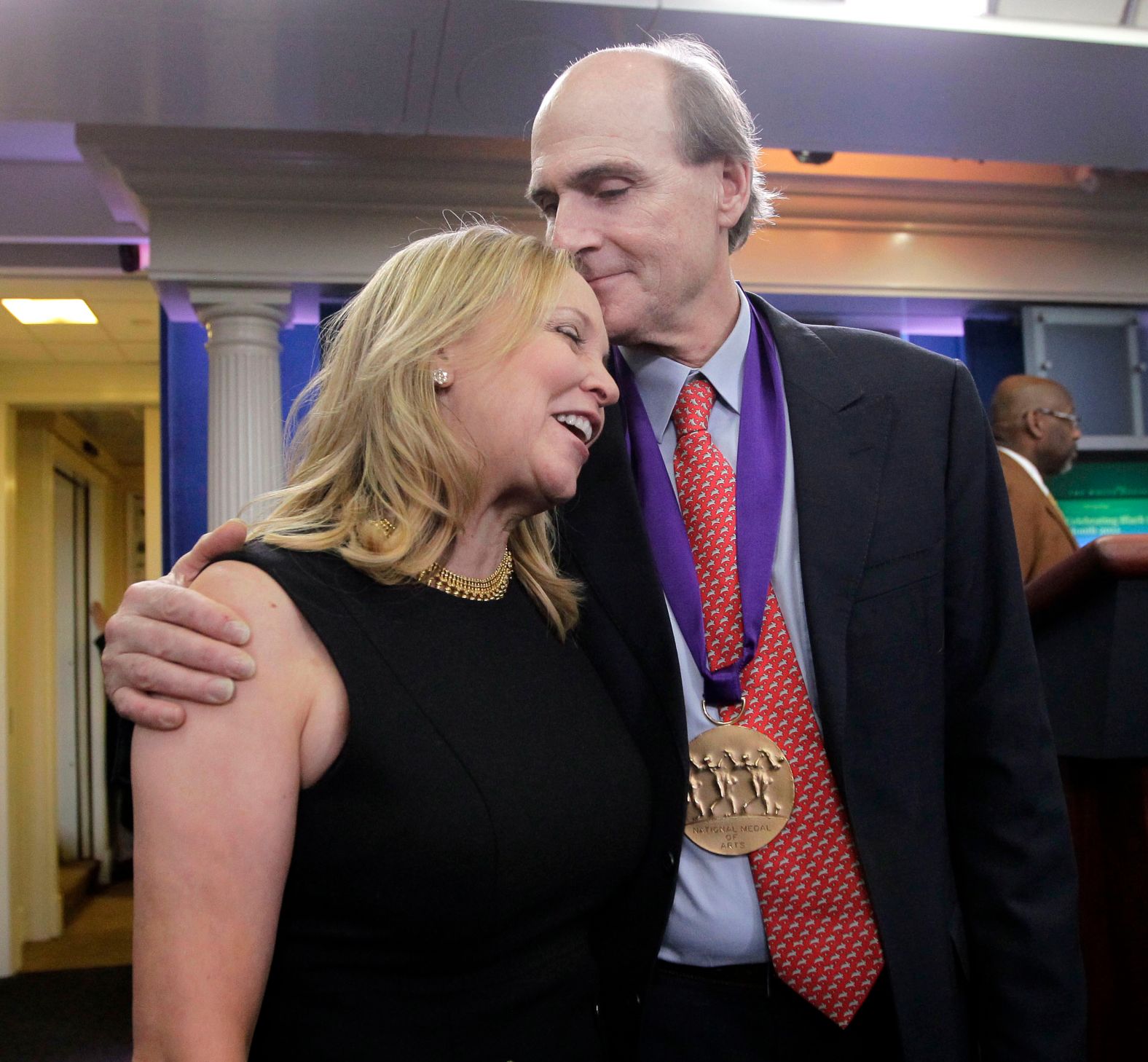 In 2011, Taylor hugs his wife, Caroline Smedvig, after receiving the <a href="index.php?page=&url=http%3A%2F%2Fwww.cnn.com%2F2011%2FPOLITICS%2F03%2F02%2Fobama.arts.humanities%2Findex.html" target="_blank">National Medal of Arts.</a> President Obama presented him the award in Washington.