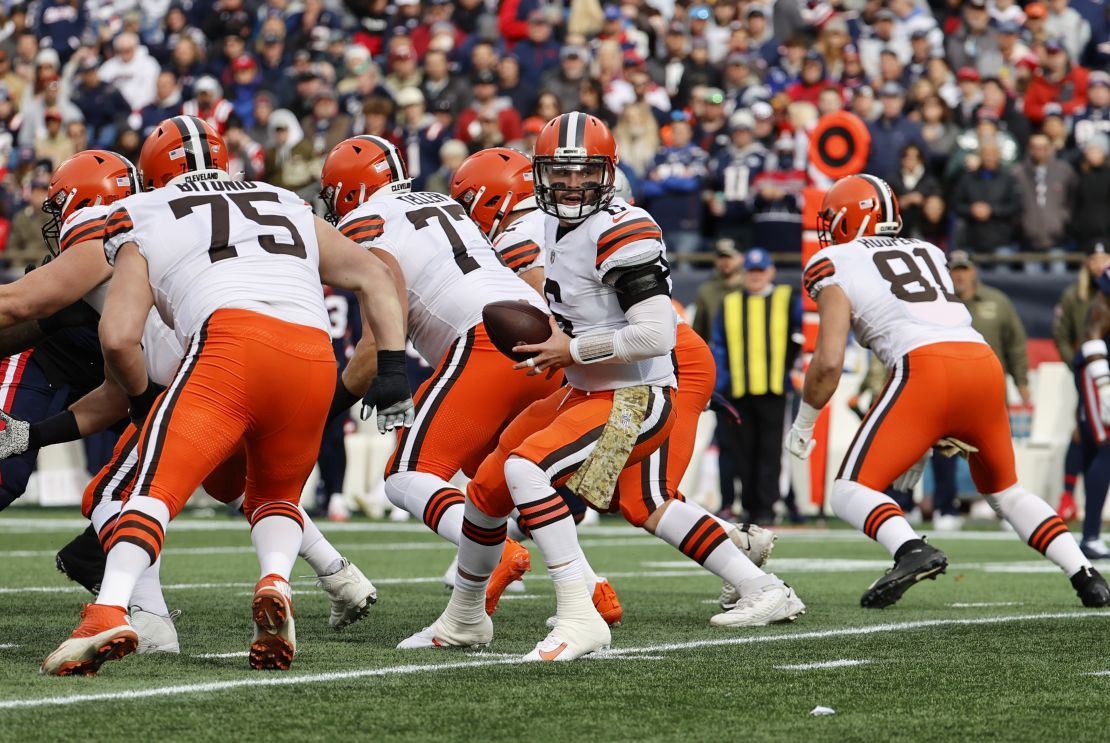 Mayfield turns to hand the ball off during the game against the New England Patriots.
