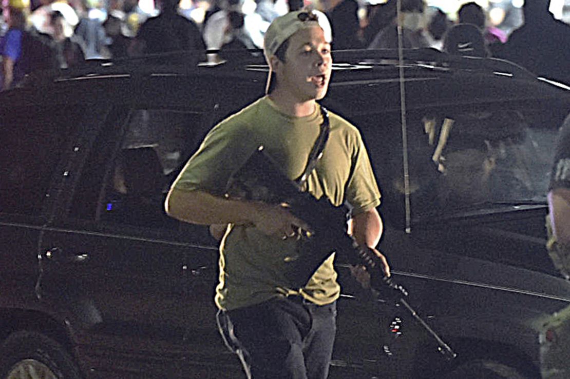 Kyle Rittenhouse carries a rifle in  Kenosha, Wisconsin, on August 25, 2020, during a night of unrest following the police shooting of Jacob Blake. Rittenhouse shot three people, two fatally, that night but was acquitted this week after claiming self-defense.