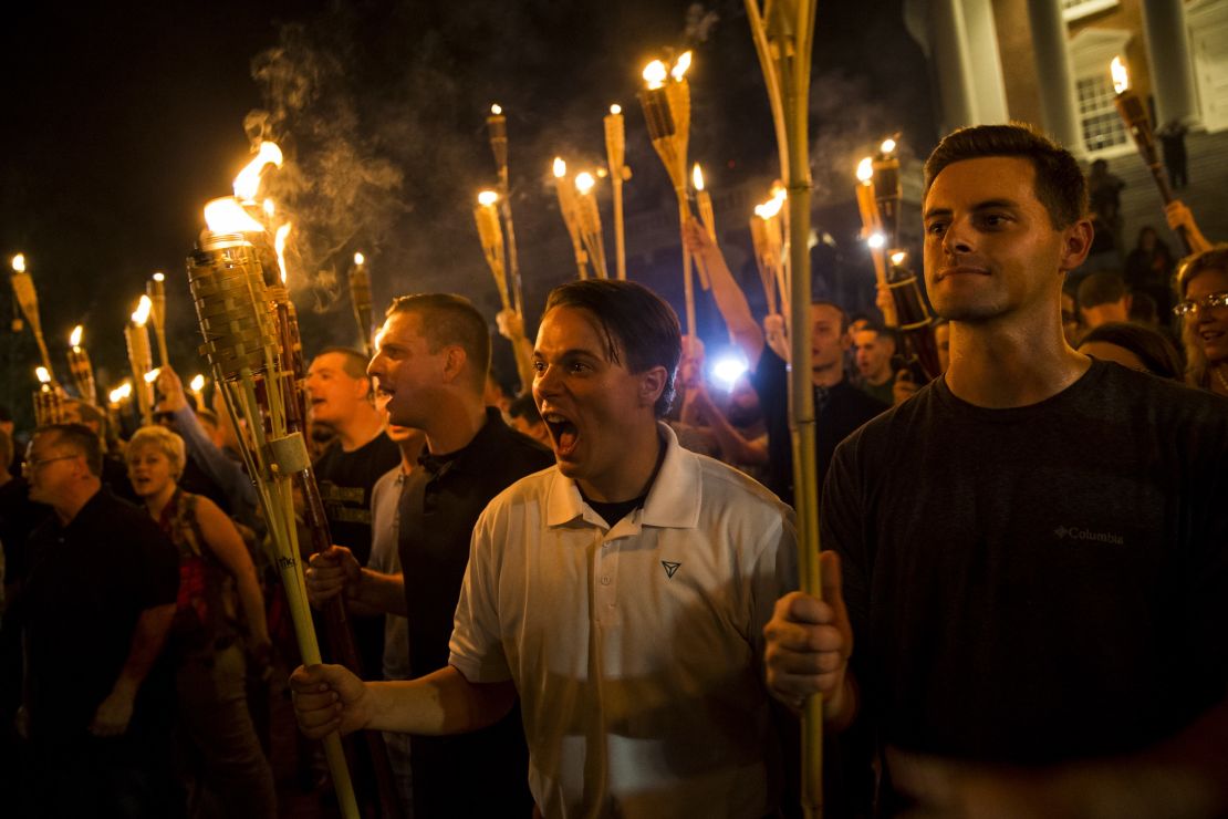 White supremacists chant at counter protesters after marching through the University of Virginia campus with torches in Charlottesville, Virginia, on August 11, 2017.