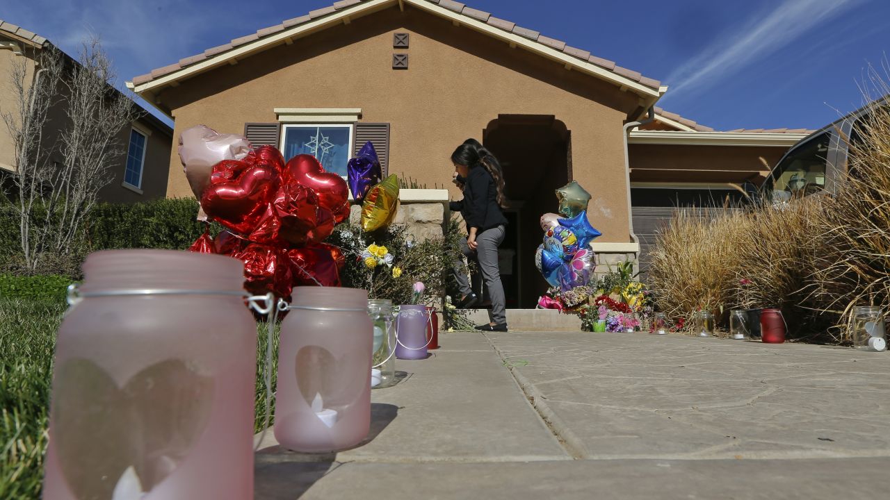 Neighbors write down messages for the Turpin's children on the front door of the home of David and Louise Turpin where police arrested the couple accused of holding 13 children captive.