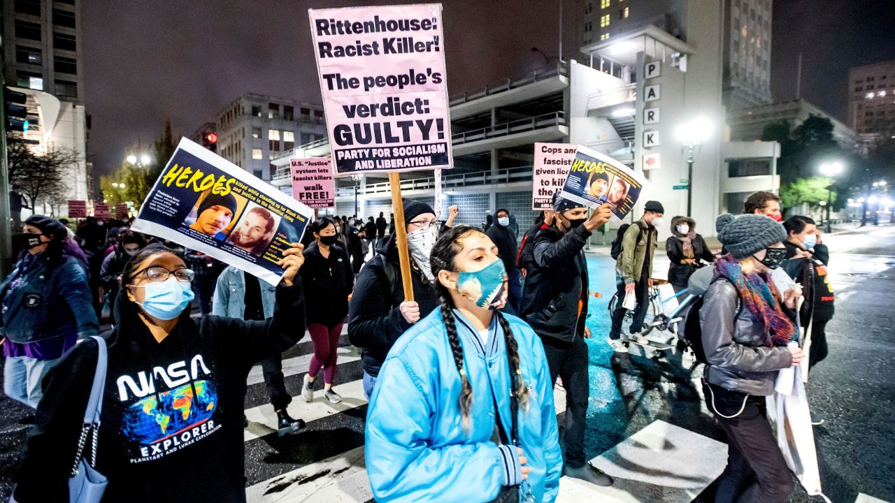 Demonstrators march through Oakland, California, to protest the acquittal of Kyle Rittenhouse on November 19, 2021.