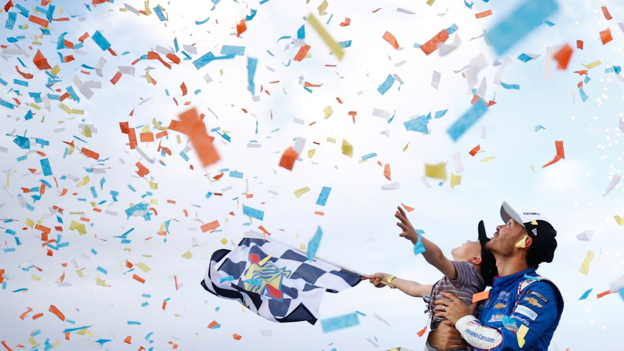 Kyle Larson, driver of the #5 HendrickCars.com Chevrolet, celebrates with his son, Owen in victory lane after winning the NASCAR Cup Series Championship at Phoenix Raceway on November 07, 2021 in Avondale, Arizona.