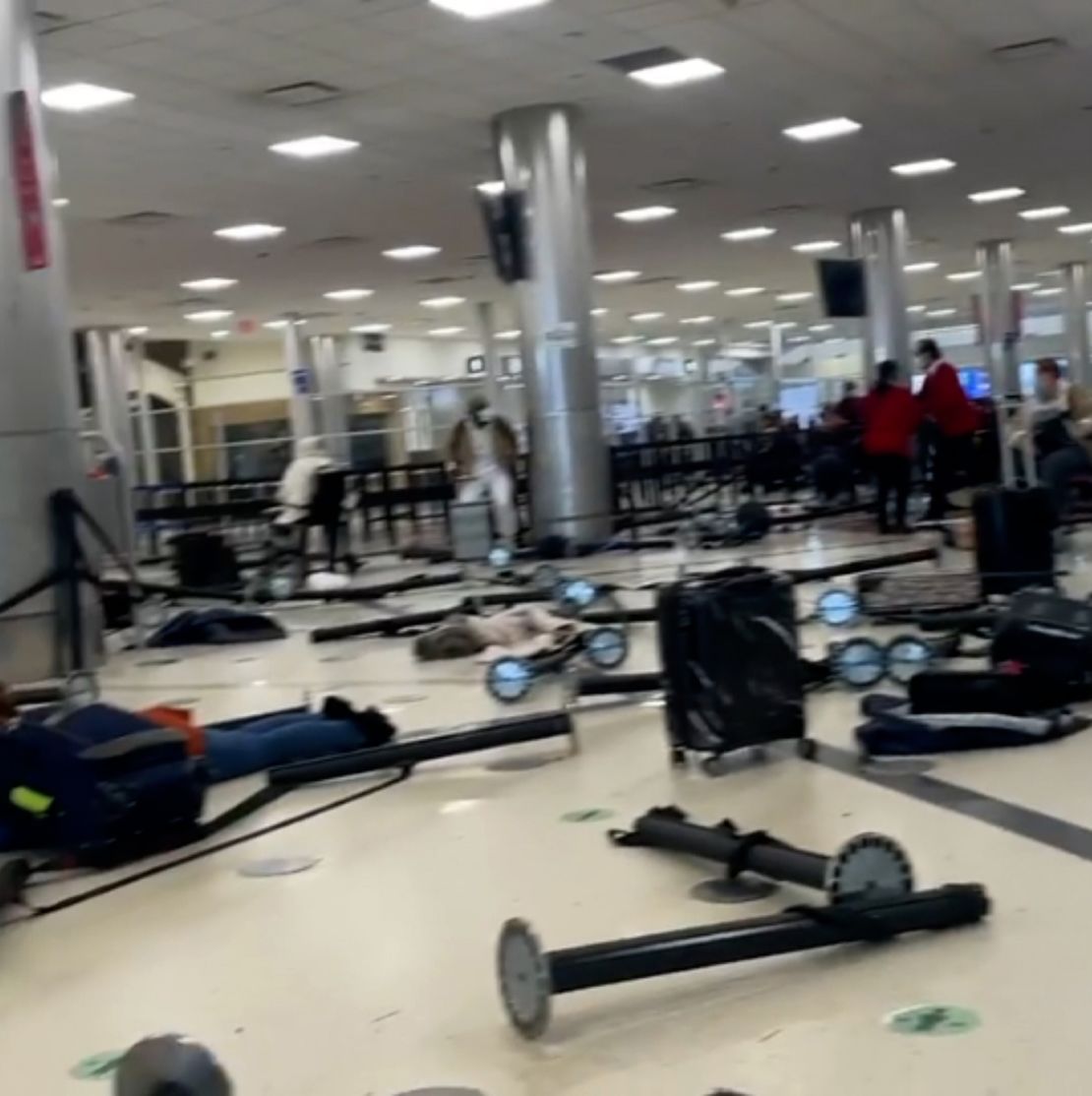 A still image taken from a video shared by a witness shows airport line dividers knocked over