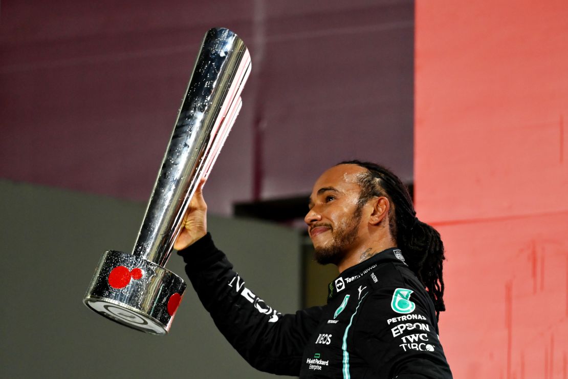 Lewis Hamilton celebrates on the podium after winning the Qatar Grand Prix.