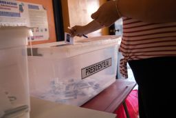 A voter casts her ballot during national elections on November 21, 2021 in Arica, Chile. 