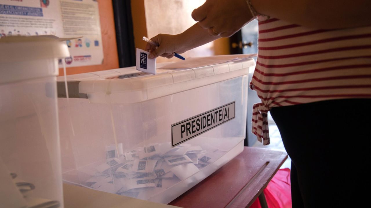 A voter casts her ballot during national elections on November 21, 2021 in Arica, Chile.