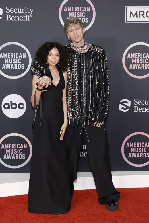 Machine Gun Kelly wore a chain and metal eyelet embellished tunic by Ashton Michael and a punk spiked collar. He was accompanied by his daughter, Casie Colson Baker, and the pair were photographed making pinky promises on the carpet.