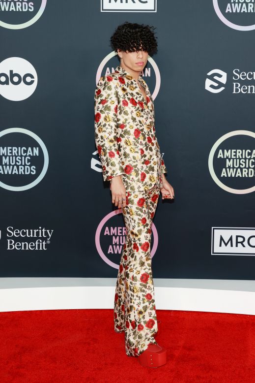 Larray's floral-printed suit by Gucci was a tasteful reminder of the bright summer months and his gigantic red platform heels made a major statement. Larray, who decided against a shirt for the outfit, also revealed on the red carpet that words had been embroidered into the back of his blazer which read, "Music is mine / Gucci Seats / Reclined."