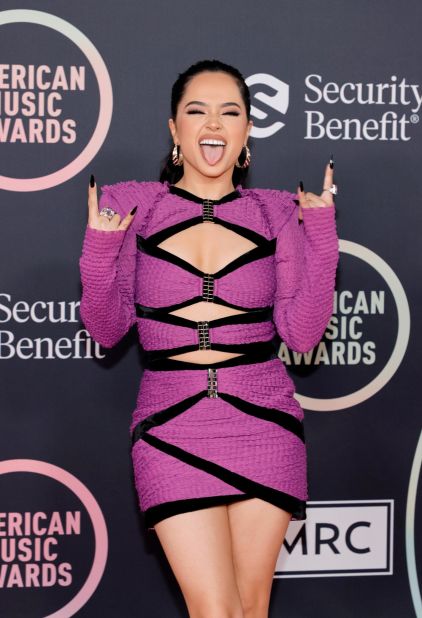 Singer Becky G arrived in a purple and black Raisa Vanessa cocktail dress with power shoulders and cut-outs.