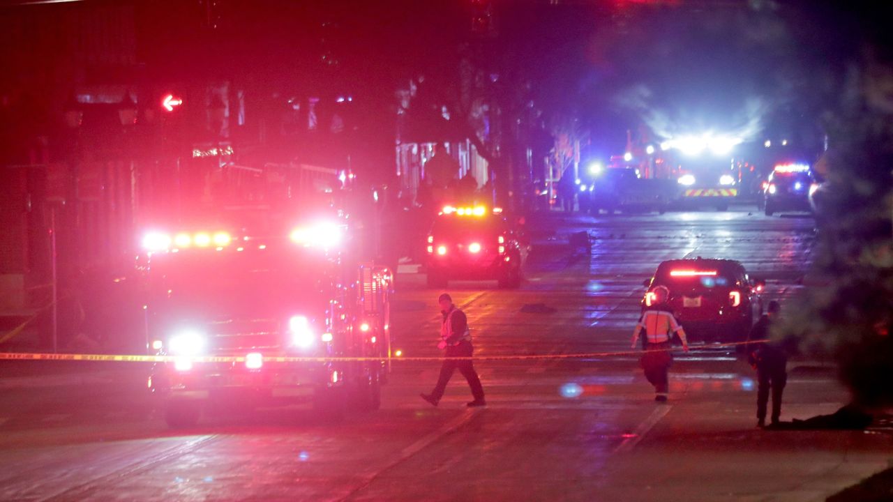 Police investigate at the scene of a crash involving multiple people and injuries at a holiday parade in Waukesha, Wis., on Sunday, Nov. 21, 2021. (Mike De Sisti/Milwaukee Journal-Sentinel via AP)