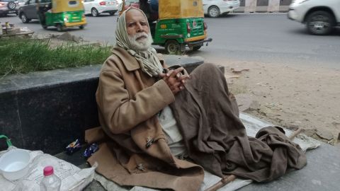 Gulpreet Singh begs for food outside Delhi's South Campus station. He struggles to breathe in the pollution.