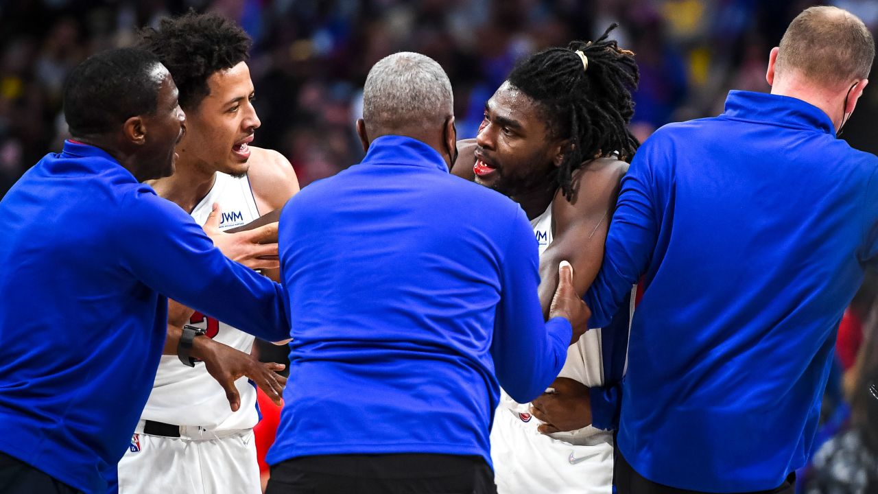 Head coach Dwane Casey of the Detroit Pistons and Cade Cunningham #2 calm down Isaiah Stewart #28 after Stewart was struck by LA Lakers' LeBron James during a game Sunday