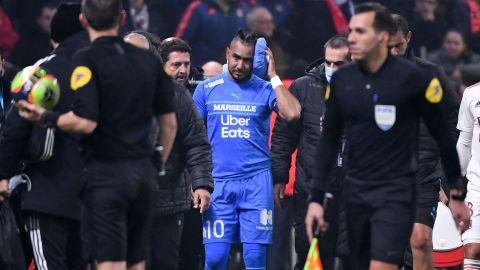 Payet leaves the field after having received treatment from being hit by a water bottle thrown from the stands during the Lyon and Marseille match. 
