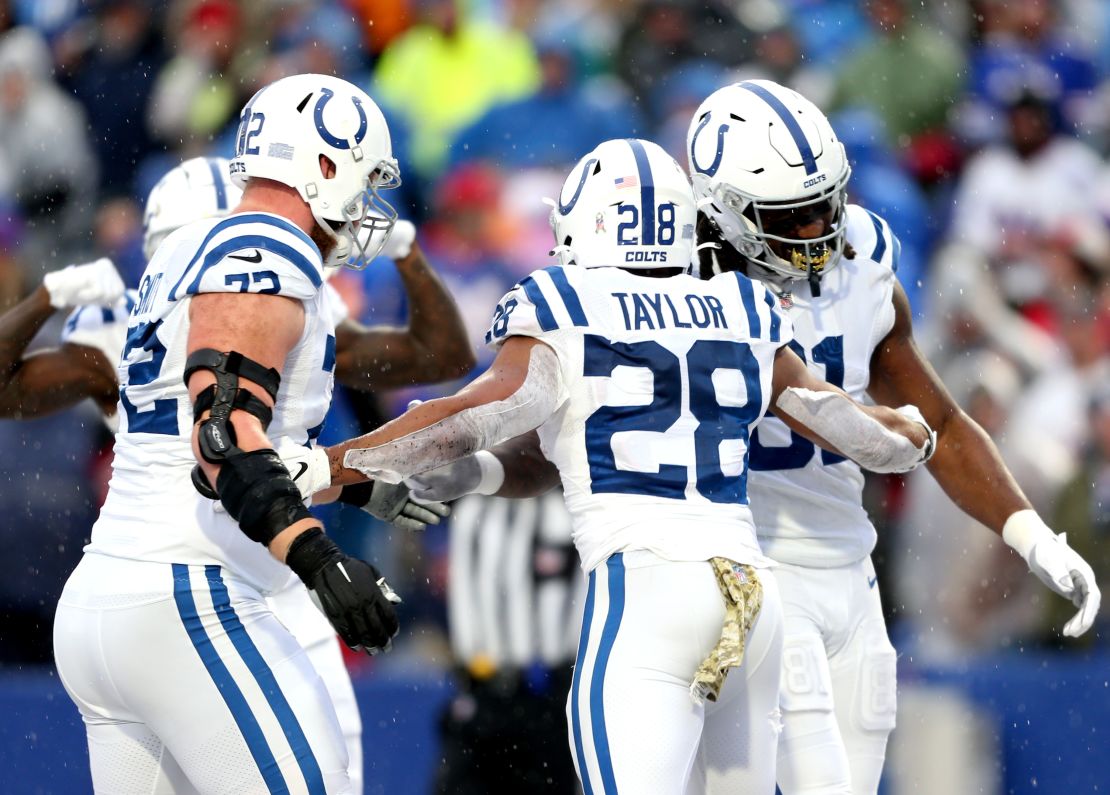 Taylor celebrates a touchdown with his teammates during the game against the Bills.
