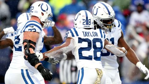 Taylor celebrates a touchdown with his teammates during the game against the Bills.