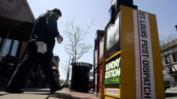 A man walks past a St. Louis Post-Dispatch newspaper box in St. Louis on April 21, 2008.