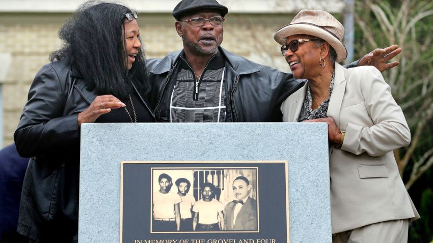 Relatives of the Groveland Four, from left, Vivian Shepherd, niece of Sam Shepherd, Gerald Threat, nephew of Walter Irvin; Carol Greenlee, daughter of Charles Greenlee, gather at the just-unveiled monument in front of the Old Lake County courthouse in Tavares, Fla., Friday, Feb. 21, 2020. Saying they were denied fundamental rights, local prosecutor Bill Gladson has filed a motion to clear the names of the four men who were wrongly accused of raping a white woman more than seven decades ago in what is considered one of the greatest miscarriages of justice in Jim Crow-era Florida. Gladson filed a motion on Monday, Oct. 25, 2021 to dismiss the indictments of Ernest Thomas and Samuel Shepherd and to set aside the judgments and sentences of Charles Greenlee and Walter Irvin. (Joe Burbank/Orlando Sentinel via AP)