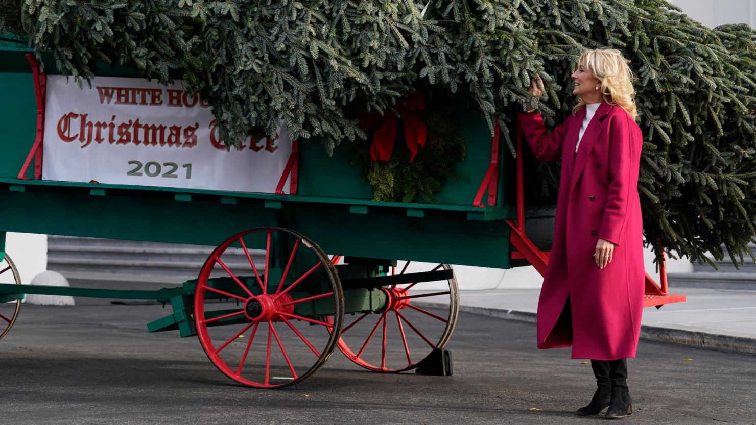 First lady Jill Biden receives the official 2021 White House Christmas tree at the White House, Monday, Nov. 22, 2021, in Washington. This year's tree is an 18.5-foot Fraser fir presented by Rusty and Beau Estes of Peak Farms in Jefferson, North Carolina.