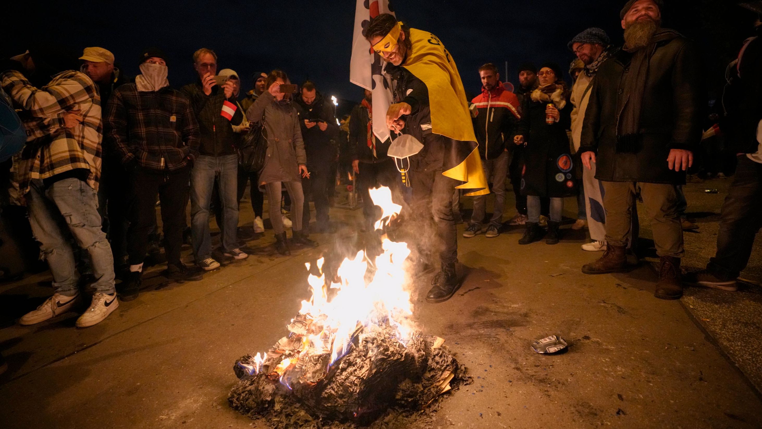 A protester burns a face mask during an anti-lockdown demonstration in Vienna, Austria, on Saturday.