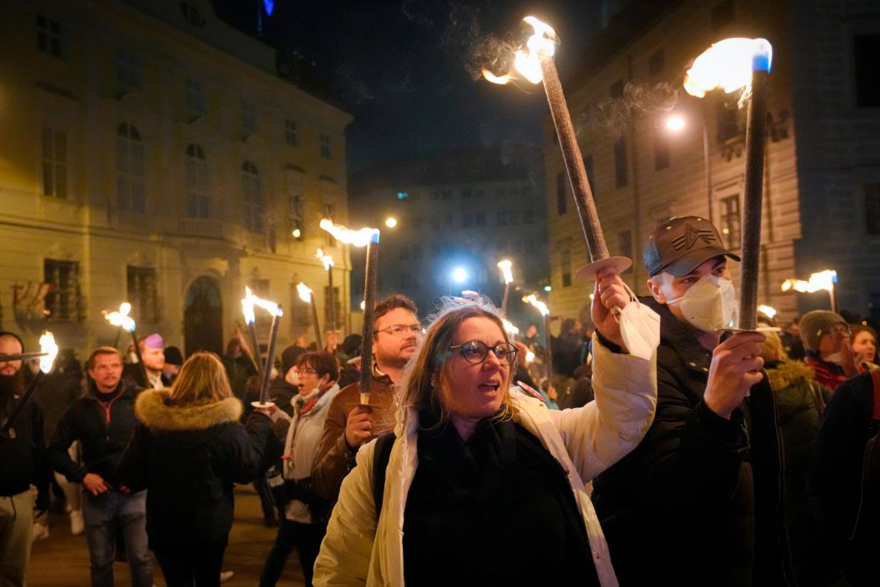 Anti-lockdown protesters hold torches in Vienna on Saturday.
