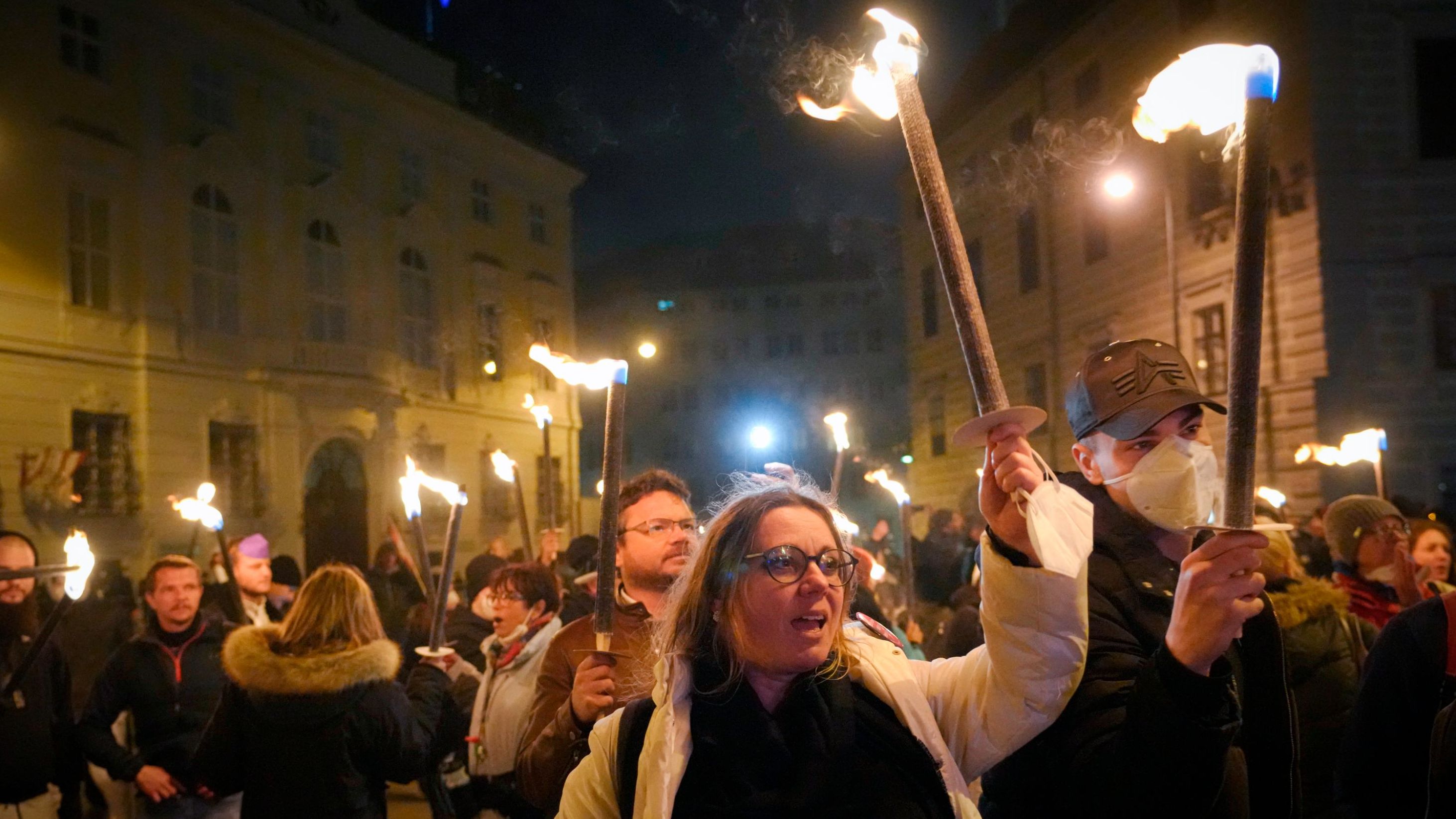 Anti-lockdown protesters hold torches in Vienna on Saturday.