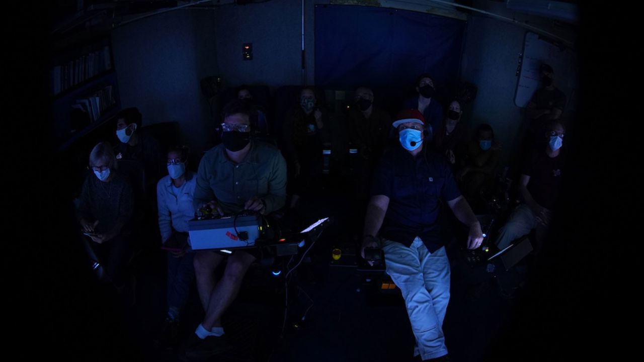 The science team eagerly watches as MBARI ROV pilot Randy Prickett maneuvers the submersible toward the tusk.
