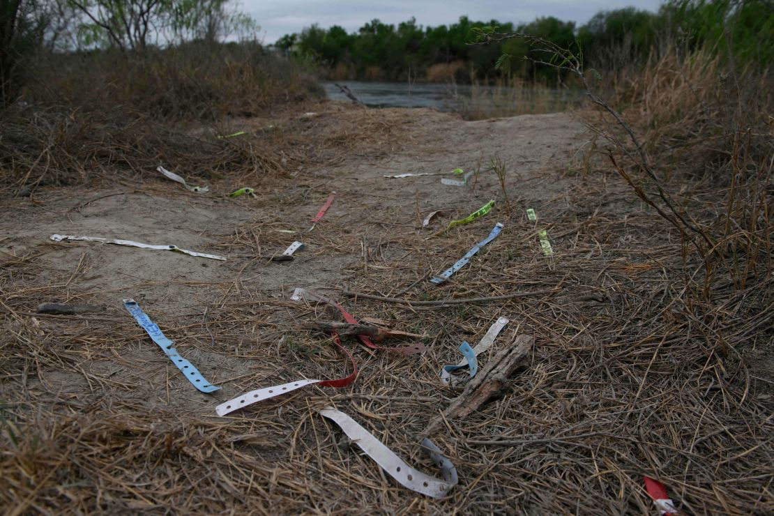 Bracelets used by smugglers and inscribed with the names of immigrants who crossed illegally from Mexico to the US to seek asylum are discarded near the Rio Grande.