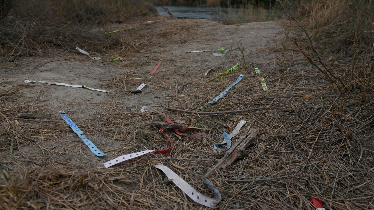 Bracelets used by smugglers and inscribed with the names of immigrants who crossed illegally from Mexico to the US to seek asylum are discarded near the Rio Grande.
